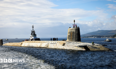 A shot of a Vanguard submarine half submerged in the water.