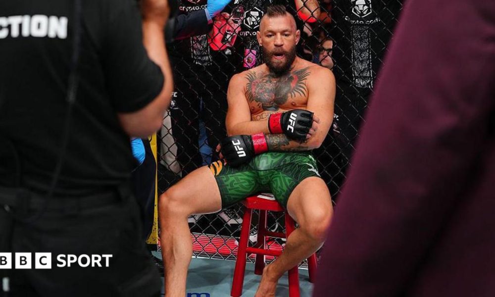 Conor McGregor sits on a stool