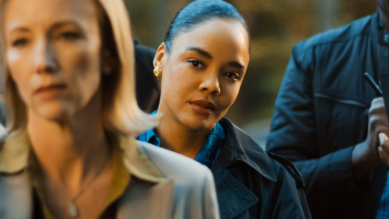 Tessa Thompson's Anna smirking in the crowd in His & Hers