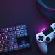 Top down view of colorful illuminated gaming accessories laying on table.
