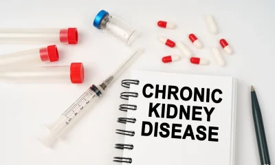 On the table are pills, injections, a syringe and a notepad with the inscription - chronic kidney disease