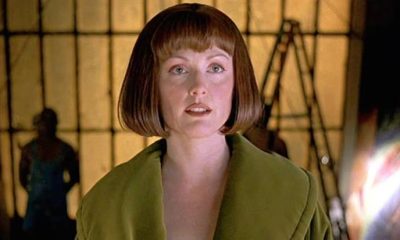 Julianne Moore as Maude Lebowski standing in front of art looking past the camera in The Big Lebowski, 1998.
