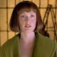 Julianne Moore as Maude Lebowski standing in front of art looking past the camera in The Big Lebowski, 1998.