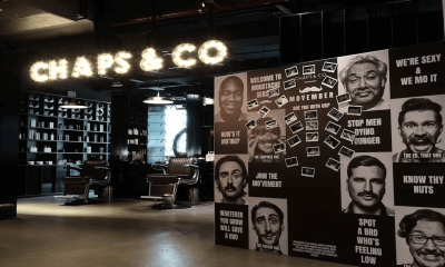 Men's faces artwork decorating a salon wall