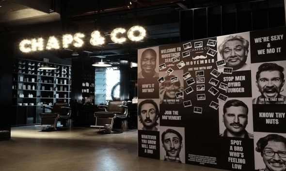 Men's faces artwork decorating a salon wall