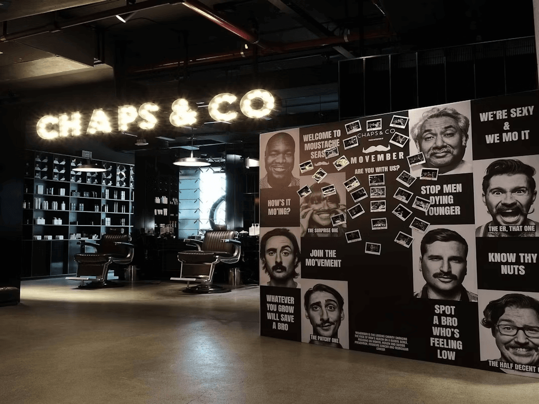 Men's faces artwork decorating a salon wall