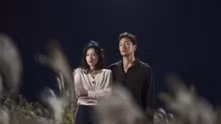 Kim Ji-won and Son Suk-ku standing in a field and embracing in My Liberation Notes