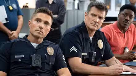 Eric Winter as Tim Bradford, Nathan Fillion as John Nolan, and Tru Valentino as Aaron Thorsen sitting together in The Rookie