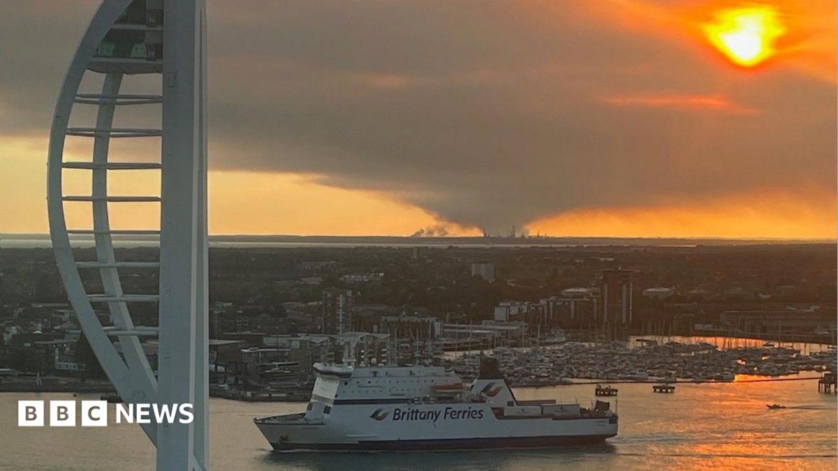 New Forest fire seen from Portsmouth with the Spinnaker Tower and ferry in the foreground.