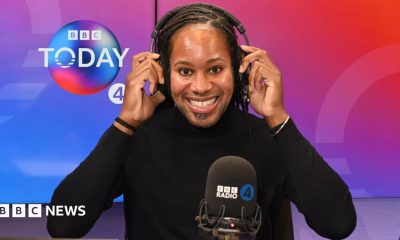 Holding headphones on his head, BBC Radio 4 Today Christmas guest editor Prof Jason Arday smiles at the camera in the studio.
