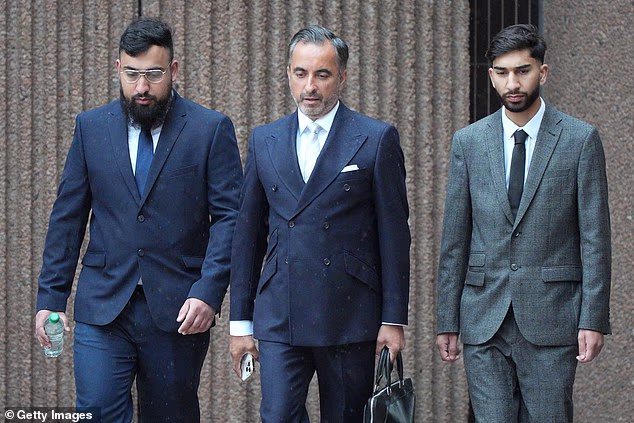 Muhammad Amaad, 26, (left) and his brother Mohammed Fahir Amaaz, 21, (right) arriving for their trial at Liverpool Crown Court either side of their solicitor, Aamer Anwar