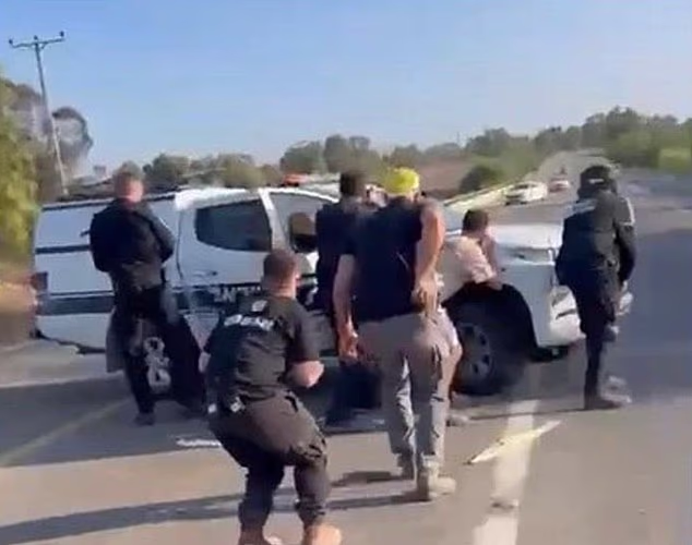 Bar Kupershtein, pictured second from left, bravely stood with other armed security guards to hinder the Hamas terrorists on the road leading to the Nova festival site. Four of the men he was seen with were killed during the gun battle