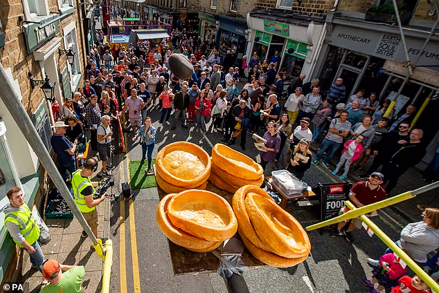 Animal rights campaigners have demanded the World Black Pudding Throwing Championships use vegan alternatives (Pictured: Attendees at the event)