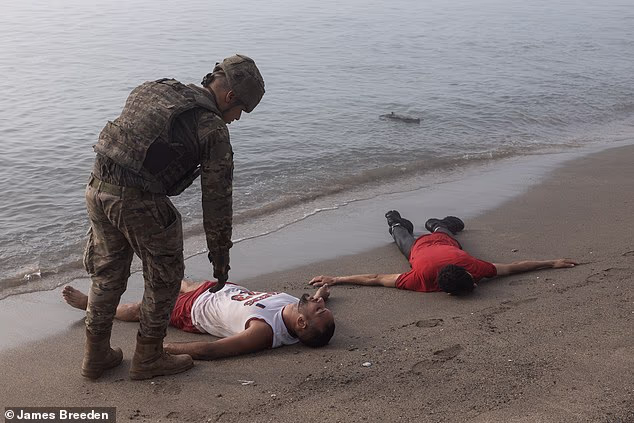 A migrant in a basketball top gasps for life as Ceuta is gripped by fear following a mass crossing of refugees from Morocco