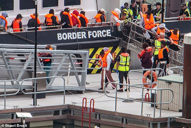 Border Force escorts migrants into Dover yesterday. Some 2,057 asylum seekers have entered the UK by small boat since Andy Burnham became PM - up from the same period last year