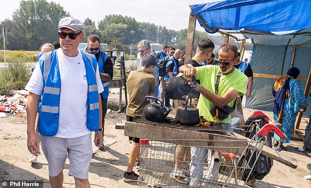 Sprawling: Reform MP Lee Anderson stands in the ¿town centre¿ of the ever-growing camp for migrants near Dunkirk
