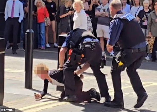 Police officers arrested a woman after four people were stabbed in central London