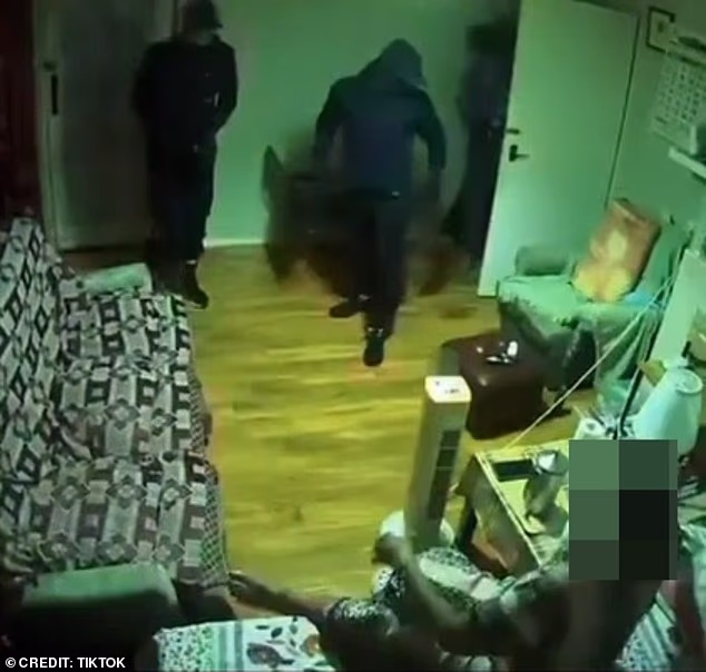 In Ring camera footage, an 83-year-old woman can be seen sleeping in her bed at her home in Hayes, west London, when four balaclava-clad men burst in