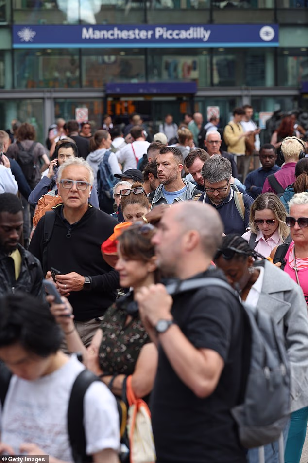 Passengers wait outside Manchester Piccadilly. Network Rail has warned that commuters across the North West of England can expect disruption for the rest of the day