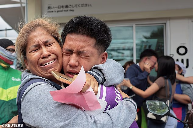 A student reunites with a relative after being evacuated from Debsirin Nonthaburi School