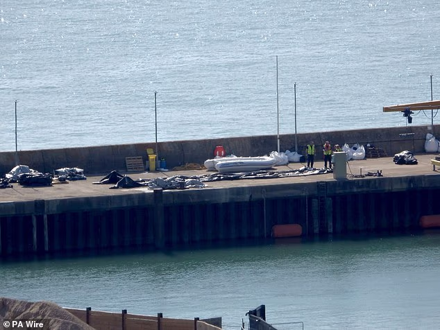 The migrant mega-dinghy - pictured in Dover today - with 230 people aboard reached Britain overnight