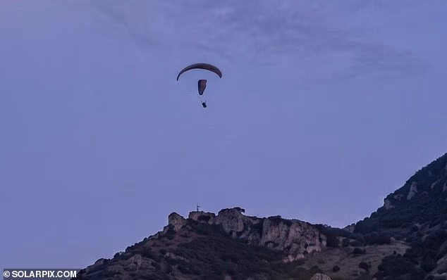 A migrant was seen attempting to paraglide into Europe just a day after another died while attempting the same stunt