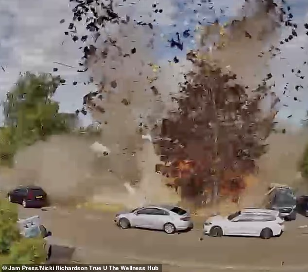 Footage shows bricks and debris flying out onto the street, damaging nearby homes and cars