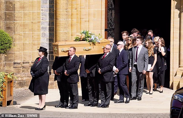 Ann Widdecombe's coffin is carried out of Buckfast Abbey following the requiem mass