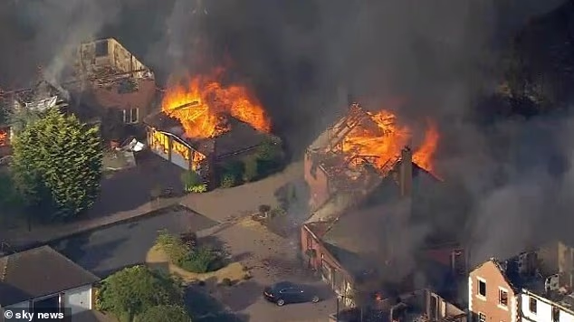 'Ash has been raining down on us from the sky for hours': On the hottest day of the year, rampant wildfires engulf streets of family homes across the country