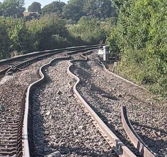 Experts suggest that soaring temperatures may have caused the tracks or embankment beneath them to buckle before the train derailment in East Sussex