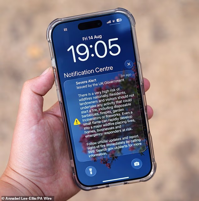 A wildfire alert issued by the UK Government seen on a mobile phone screen yesterday
