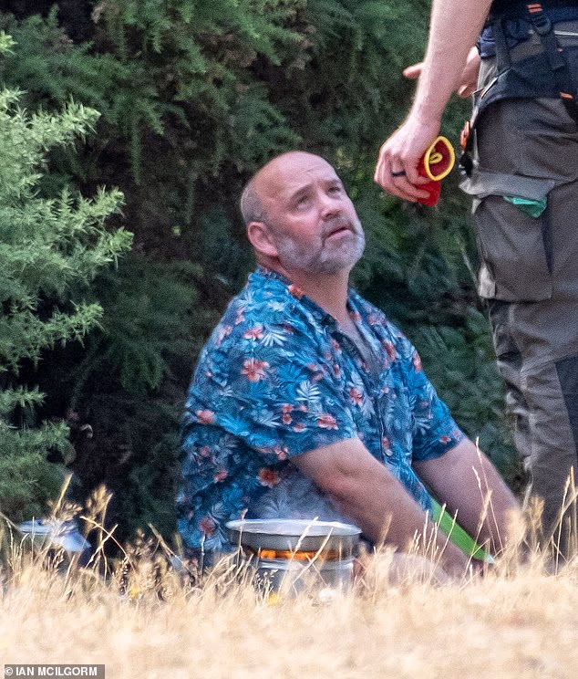The would-be chef looked annoyed as his defiance of national warnings against open flames outdoors was questioned by a National Trust ranger on Saturday