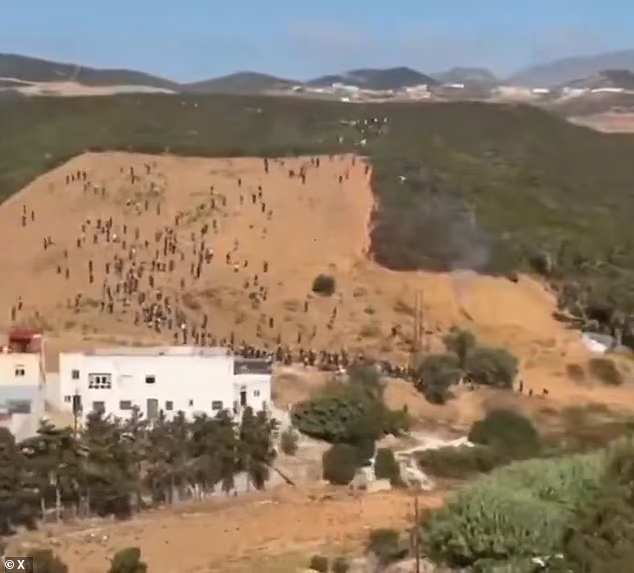 Hundreds of migrants were seen trying to storm border of Spanish enclave in planned Ceuta