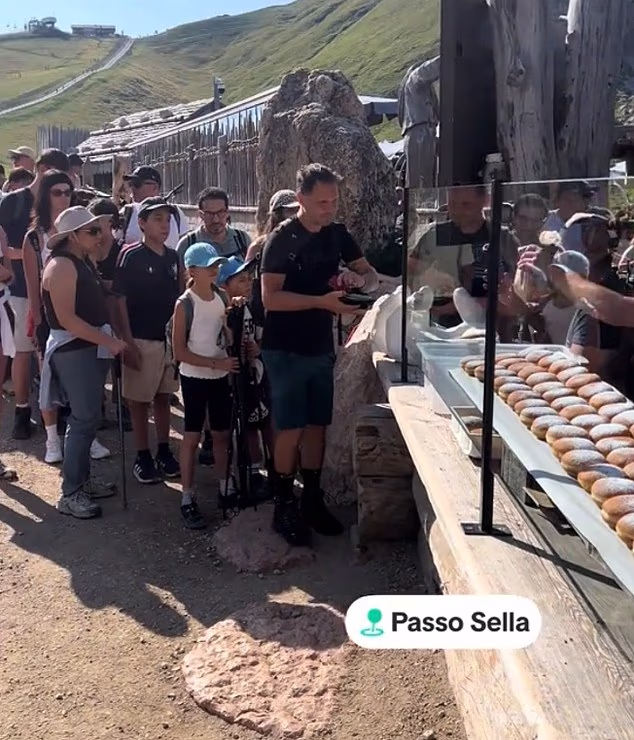 Shocking videos show an influx of tourists waiting hours at an altitude of 2,300 meters amidst the breathtaking scenery in 'mad' winding queues for famed fresh, cream-filled doughnuts