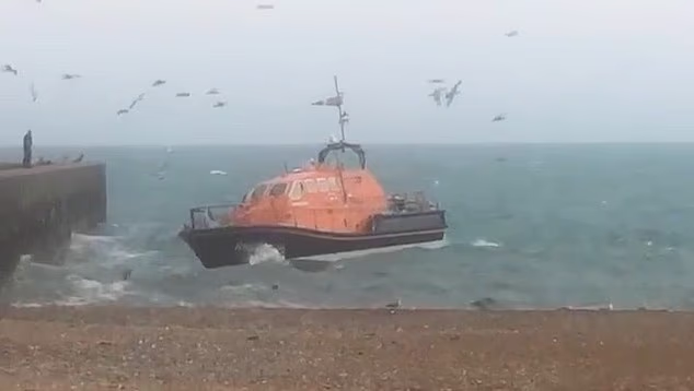Footage shows a lifeboat battling heavy seas during a desperate search for a family who drowned yesterday