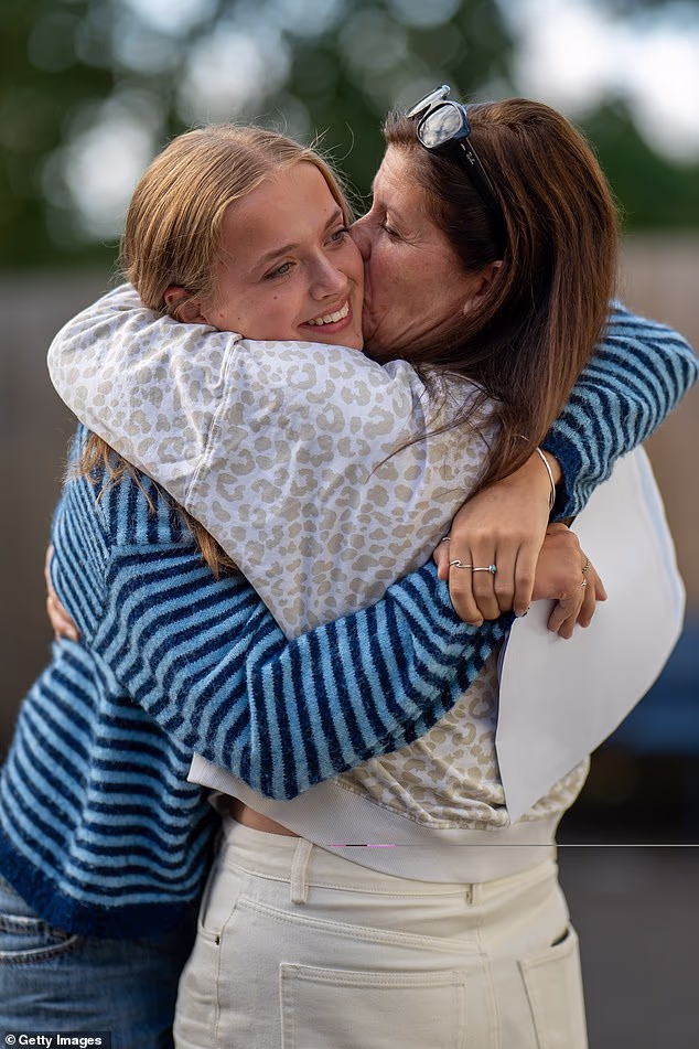 Iris Hamilton-Potter hugs her mother after receiving her GCSE results at Llanishen High School, Cardiff