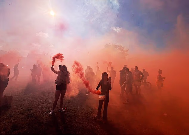 Scores of people yesterday held orange flares aloft in a field in South Bank, Middlesborough, to mark the deaths of the five 'joyriders'