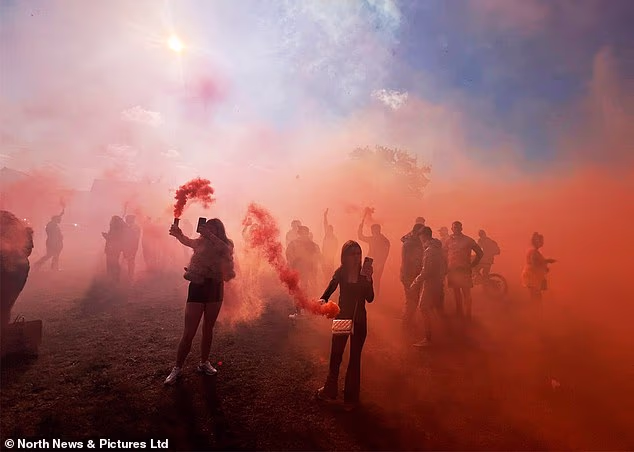 Scores of people held orange flares aloft in a field in South Bank, Middlesborough, to mark the deaths of the five joyriders