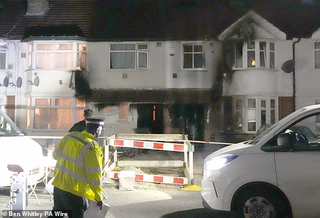Pawel Kupla has been charged in connection with a fatal house fire in Hounslow that left one dead and eight others injured (Pictured: Police outside a fire damaged property following a fire on Berkeley Avenue)