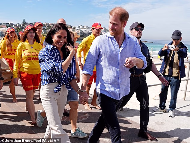 Meghan and Harry are seen here at Bondi Beach during their visit to Australia in April this year - the couple are returning to live in the UK, with questions over how their security will be funded