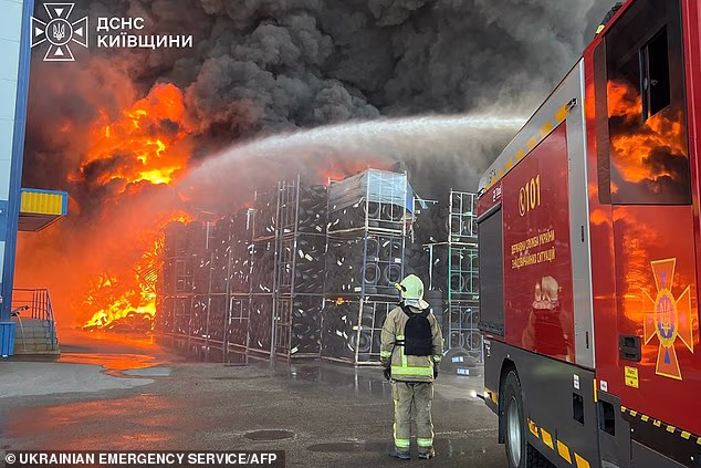 At least 37 people have been killed after Russia attacked a Ukrainian ammunition depot with a drone as strikes on Kyiv continued for a third day (Pictured: A firefighter tackles the blaze)