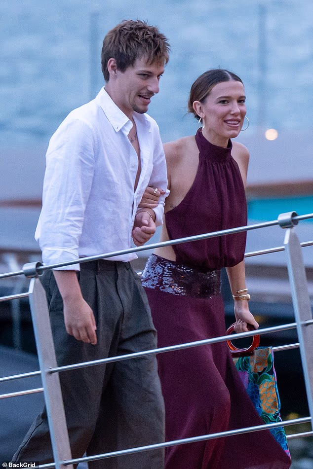 Millie Bobby Brown stunned in a backless purple maxi dress on Friday as she and husband Jake Bongiovi arrived for dinner at La Terrazza Gualtiero Marchesi in Italy's Lake Como