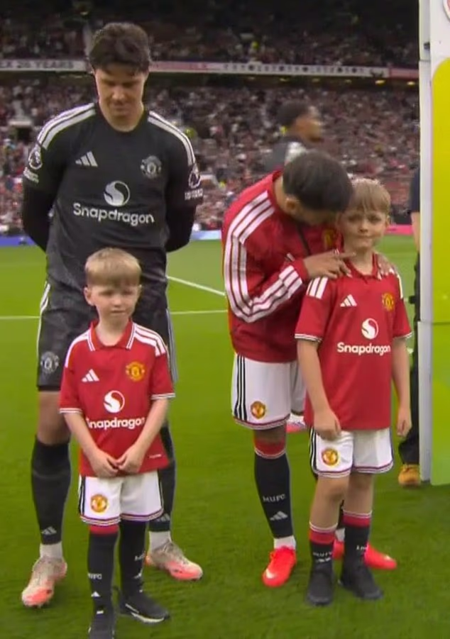 The two sons of a police officer killed in the A66 crash led out the Manchester United team as mascots for today's Premier League match against Ipswich Town