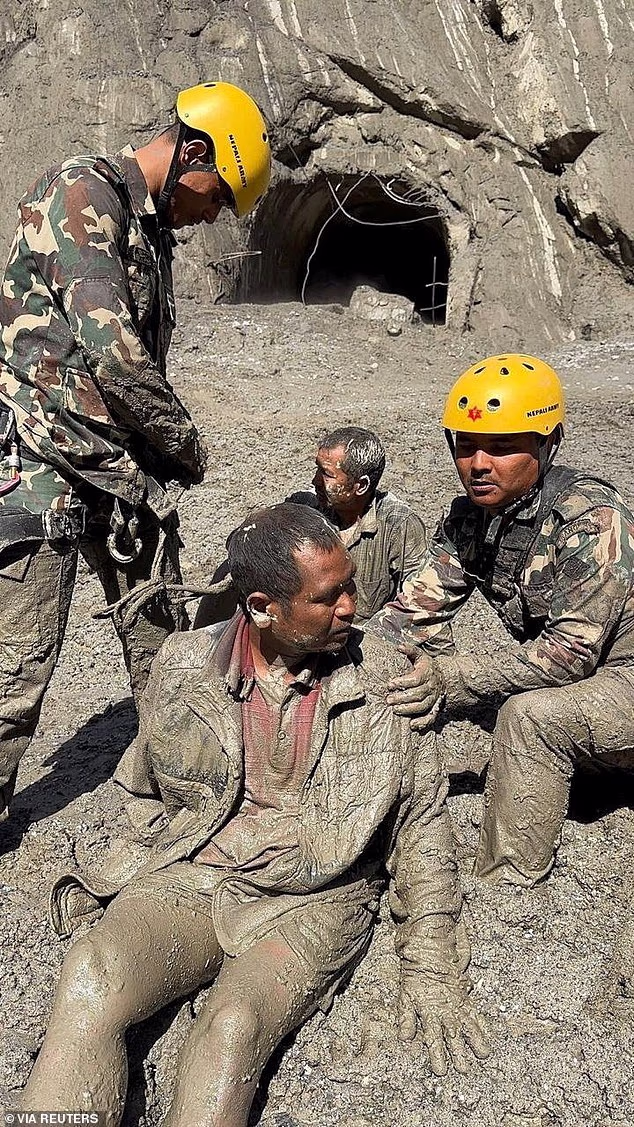Nepal Army personnel rescuing a man, following deadly flash floods and mudslides
