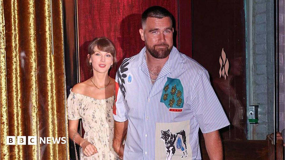 Taylor Swift and Travis Kelce were seen walking out of a restaurant on their wedding weekend in New York City. She is wearing a floral dress and he is seen in a short-sleeved button-down shirt and pants.
