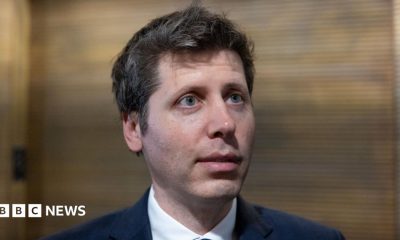 OpenAI chief Sam Altman answering questions in a hallway during a trip to Washington DC.