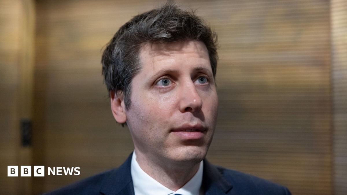 OpenAI chief Sam Altman answering questions in a hallway during a trip to Washington DC.