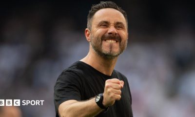 Roberto de Zerbi celebrates to the crowd by clenching a fist
