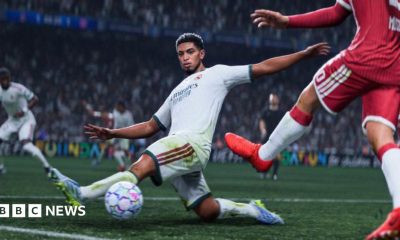 A screenshot from EA's EA FC 27, showing England's Jude Bellingham in white on the football pitch, saving a pass from the opposing team in red.