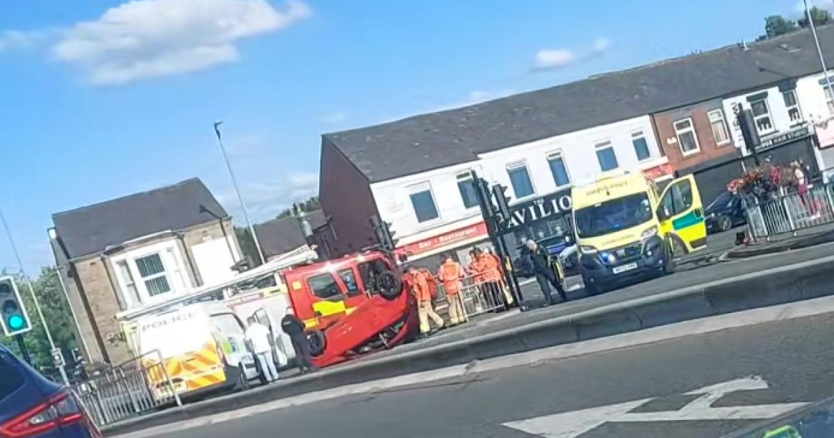 Car on roof after crash at Blackburn Road junction
